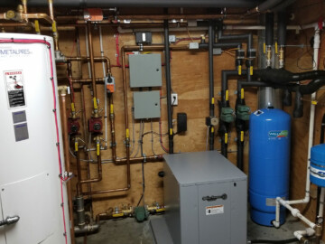 The system is a 5 ton geothermal Waterfurnace heat pump with five solar panels. The solar system will heat the house, domestic hot water and hot tub. When the solar is not enough the heat the water the heat pump automatically handles the loads. In the summer when there is to much heat being generated from the solar system the extra heat is dumped in the ground loop to be stored until it is needed.